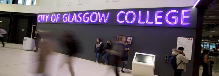 City of Glasgow College neon purple sign in the atrium at City campus