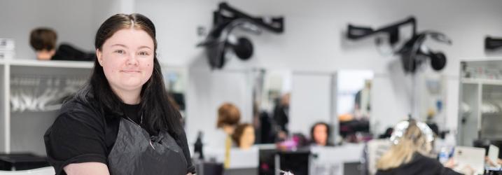 Student in the training salon washing a clients hair