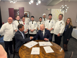 Dr Paul Little, Principal and CEO, Scotland’s National Chef and Executive Chef at the College, Gary Maclean, and Carla Gethin, Vice Principal - Corporate Development and Innovation stand with The Culinary Institute of New York at Monroe University students. 